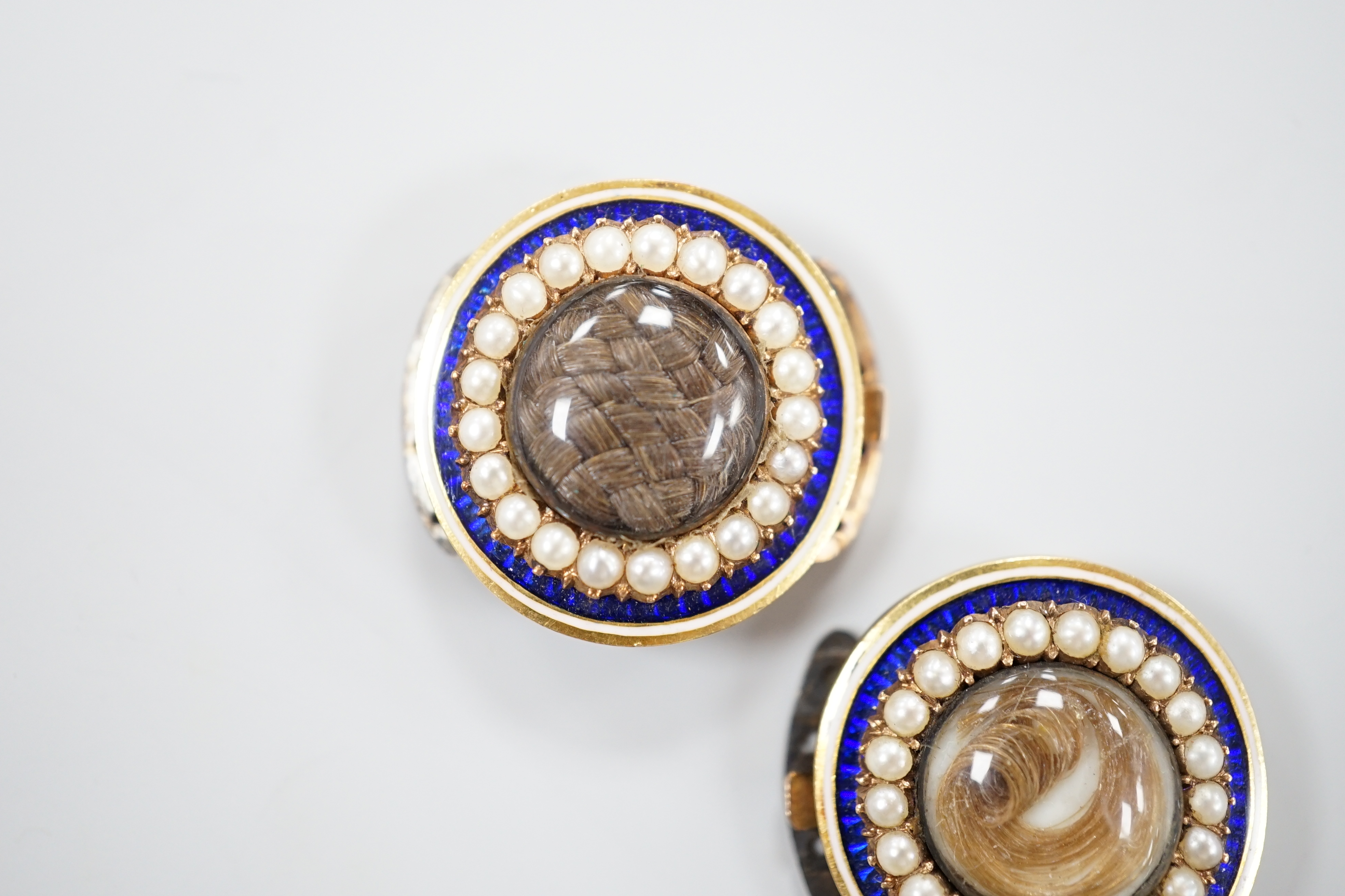 A pair of George III gold, enamel and pearl set clasps, each with differing hairwork inset and differing monogram / initials to the back, 2.25cm